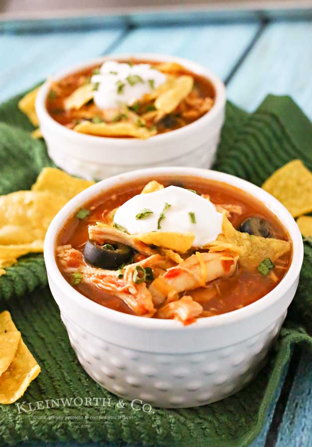 Slow Cooker Chicken Tortilla Soup is loaded with chicken, tomatoes, corn, black beans & olives in a delicious salsa verde base. Simple, hearty & DELICIOUS