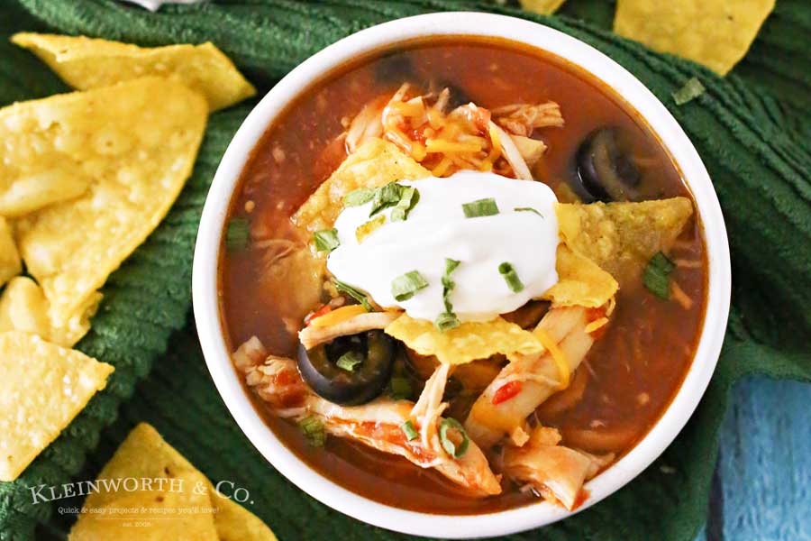 Slow Cooker Chicken Tortilla Soup is loaded with chicken, tomatoes, corn, black beans & olives in a delicious salsa verde base. Simple, hearty & DELICIOUS