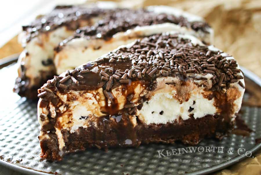 Making a homemade ice cream cake is easy. This Mint Brownie Ice Cream Cake has a brownie bottom layer & is topped with refreshing mint ice cream & chocolate syrup and sprinkles. It's an easy ice cream cake recipe that is perfect for birthdays, holidays like St. Patrick's Day or just because you love mint & chocolate together. It's out of this world! 