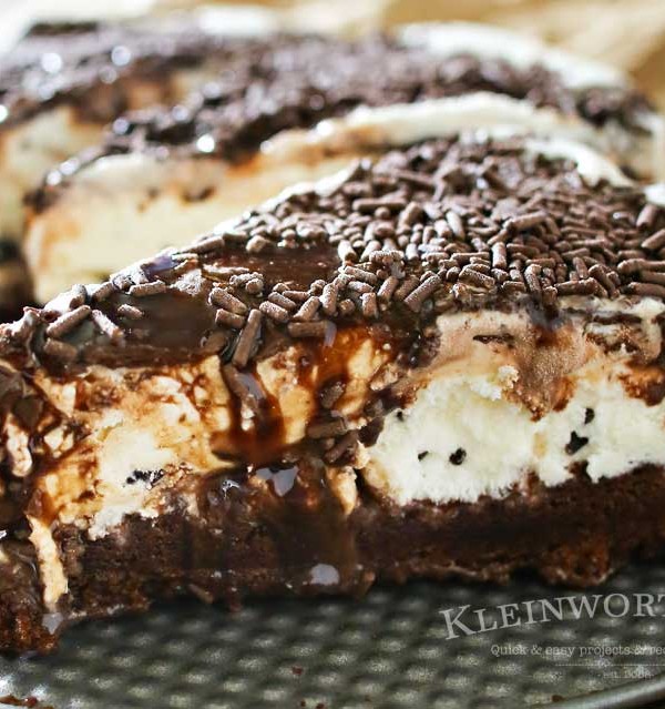 Making a homemade ice cream cake is easy. This Mint Brownie Ice Cream Cake has a brownie bottom layer & is topped with refreshing mint ice cream & chocolate syrup and sprinkles. It's an easy ice cream cake recipe that is perfect for birthdays, holidays like St. Patrick's Day or just because you love mint & chocolate together. It's out of this world!