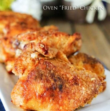 A close-up view of crispy oven-fried chicken pieces arranged on a plate. The golden-brown breading appears crunchy, giving the chicken a freshly baked and flavorful look.