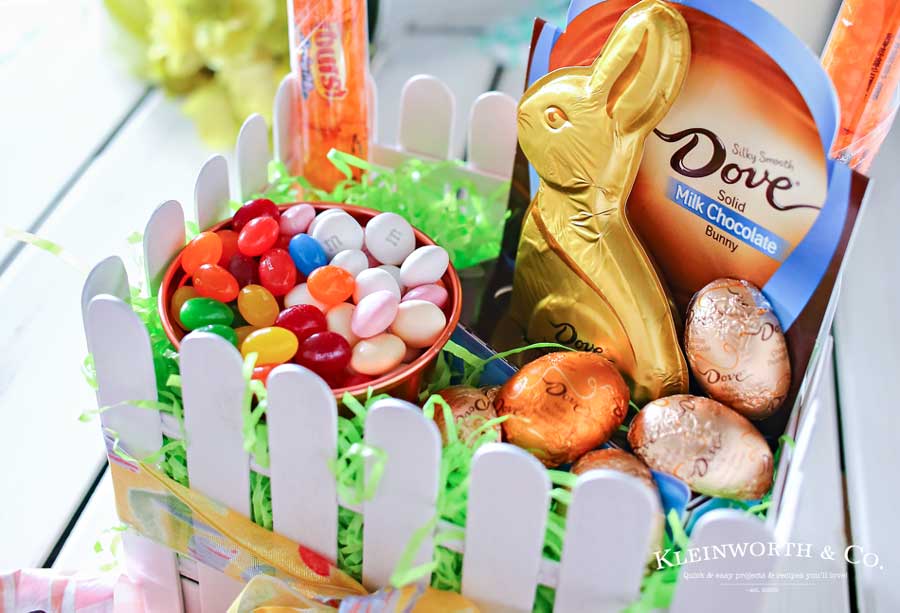 This adorable Picket Fence Easter Basket is easy to make with this step-by-step tutorial using tongue depressors or popsicle sticks. Load it full of your favorite Easter candy & you know everyone will love it. It's definitely my favorite Easter craft! Makes for a great display in an entryway for all your Easter party guests or even to decorate at your office. You won't believe just how quickly you can make your own!