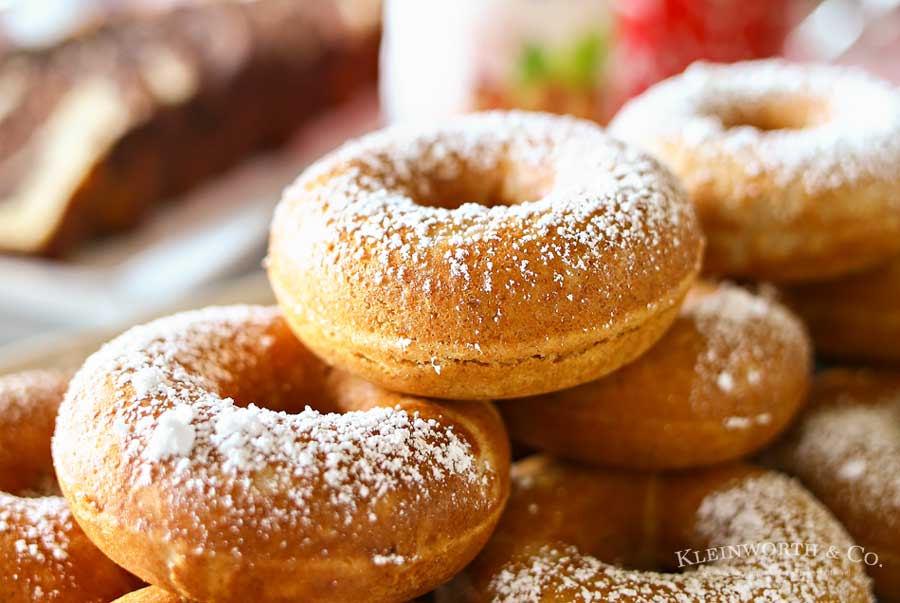 Caramel Whole Wheat Donuts are a lightened up version of the traditional baked cake donut recipe. Using whole wheat flour & just a dusting of confectioners sugar in place of frosting, they are perfect with your morning coffee or at your next brunch. Don't miss my tips for planning a coffee party too.
