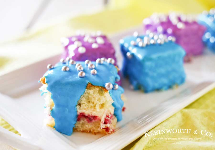 Scrumptious Petit Fours Recipe makes a perfect dessert for any celebration. Light & fluffy cake layered with jam & frosting & coated with more frosting! A favorite cake recipe that really shows it's something special. Serve these Spring Petit Fours. They are definitely the cutest little dessert and everyone will be amazed that they are homemade!