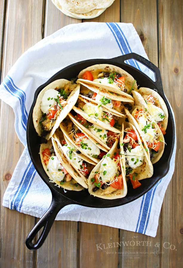 Baked Chicken Street Tacos are an easy family dinner idea. Quick to make using rotisserie chicken smothered in homemade crema & baked in the iron skillet. Seriously SO GOOD we made them twice in one weekend!