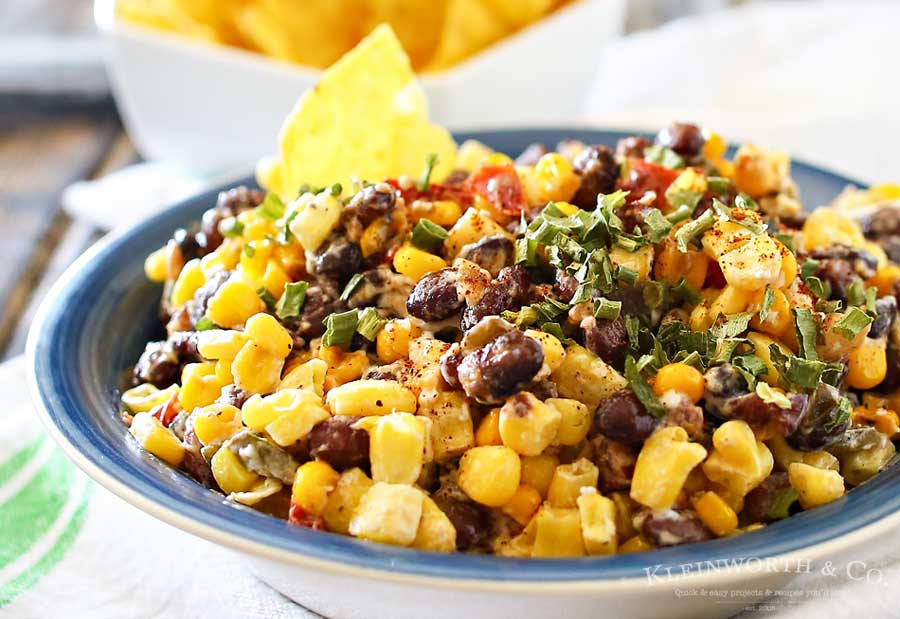 Mexican Corn Salsa is a zesty blend of corn, black beans, peppers, chiles & onions sauteed in butter & spices & mixed with a kicky lime crema. Scrumptious! It's so good by itself or mixed in other dishes.