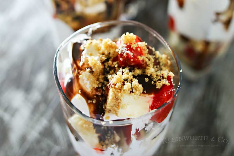 Strawberry Cheesecake Parfait is made with chunks of strawberry topped cheesecake, whipped topping, chocolate syrup & graham cracker sprinkles. A perfect easy treat to serve for Mother's Day.