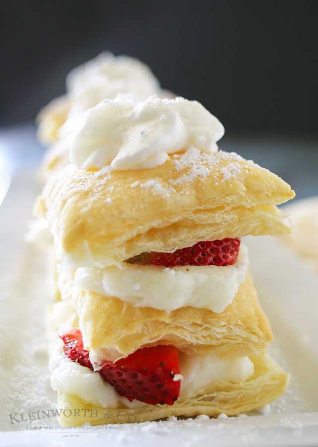 Strawberry Napoleons are an easy dessert recipe made with puff pastry, pudding, strawberries & dusted with confectioners sugar. The perfect summer dessert for any occasion.