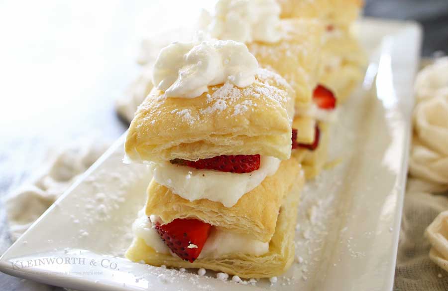 Strawberry Napoleons are an easy dessert recipe made with puff pastry, pudding, strawberries & dusted with confectioners sugar. The perfect summer dessert for any occasion.