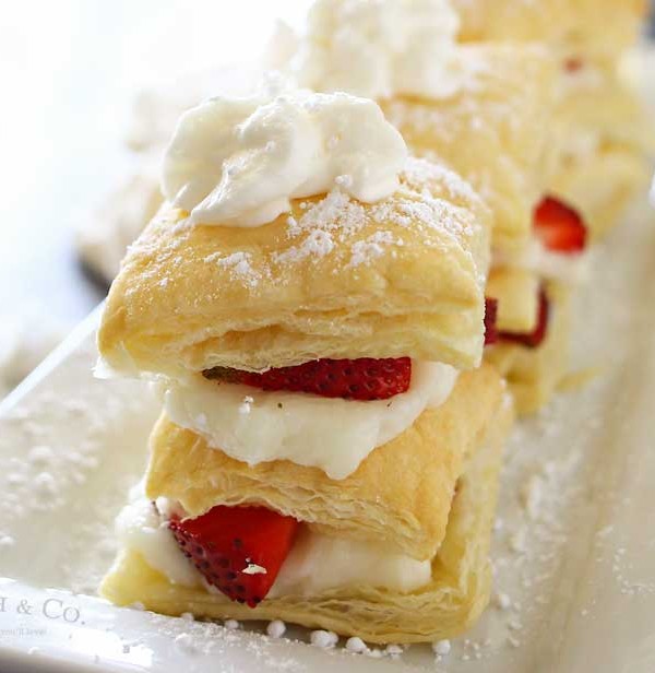 Strawberry Napoleons are an easy dessert recipe made with puff pastry, pudding, strawberries & dusted with confectioners sugar. The perfect summer dessert for any occasion.