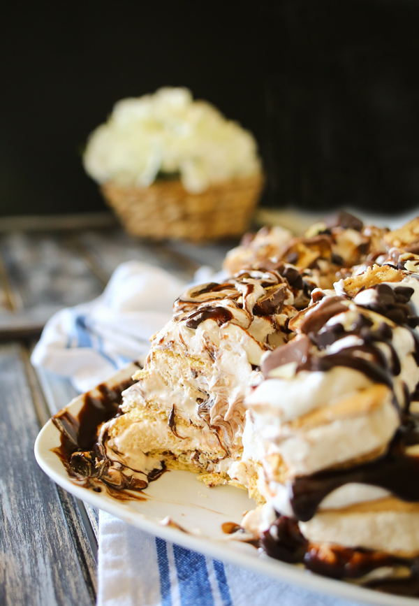 Snickers Ice Cream Cake is made with salted caramel ice cream bars, whipped cream & loaded with Snickers candy bars. It's over the top amazing!