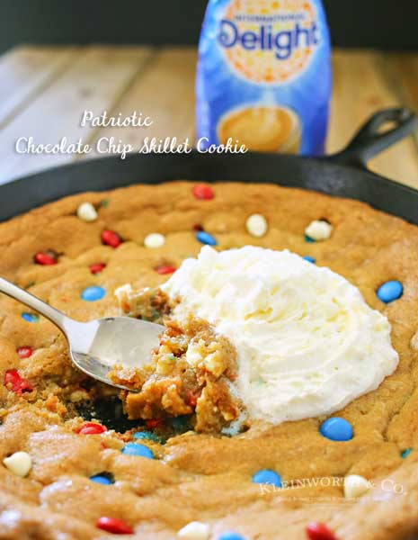 Patriotic Chocolate Chip Skillet Cookie is much like a Pizookie. A giant, thick & chewy chocolate chip cookie baked in an iron skillet with patriotic M&M's. It's absolutely INCREDIBLE! (& so easy too- mix, dump, bake, enjoy)