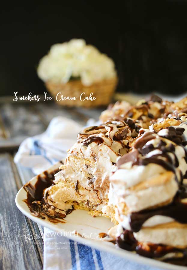 Snickers Ice Cream Cake is made with salted caramel ice cream bars, whipped cream & loaded with Snickers candy bars. It's over the top amazing!