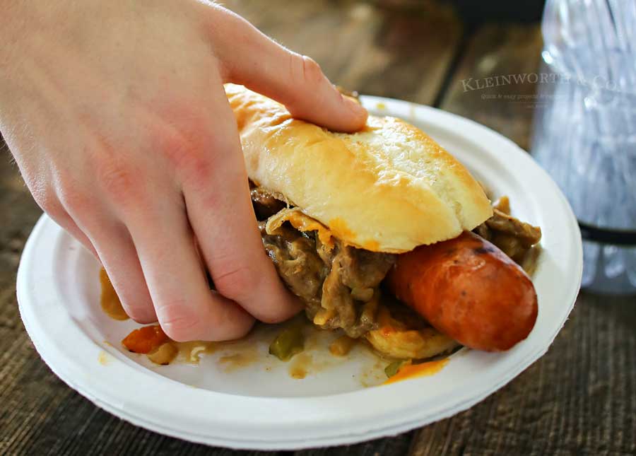 Philly Cheesesteak Hot Dog is a twist on two iconic food recipes. Combining grilled hot dogs & the best philly cheesesteak recipe is over the top amazing!