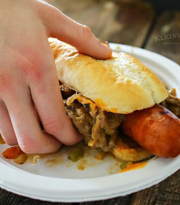 Philly Cheesesteak Hot Dog is a twist on two iconic food recipes. Combining grilled hot dogs & the best philly cheesesteak recipe is over the top amazing!