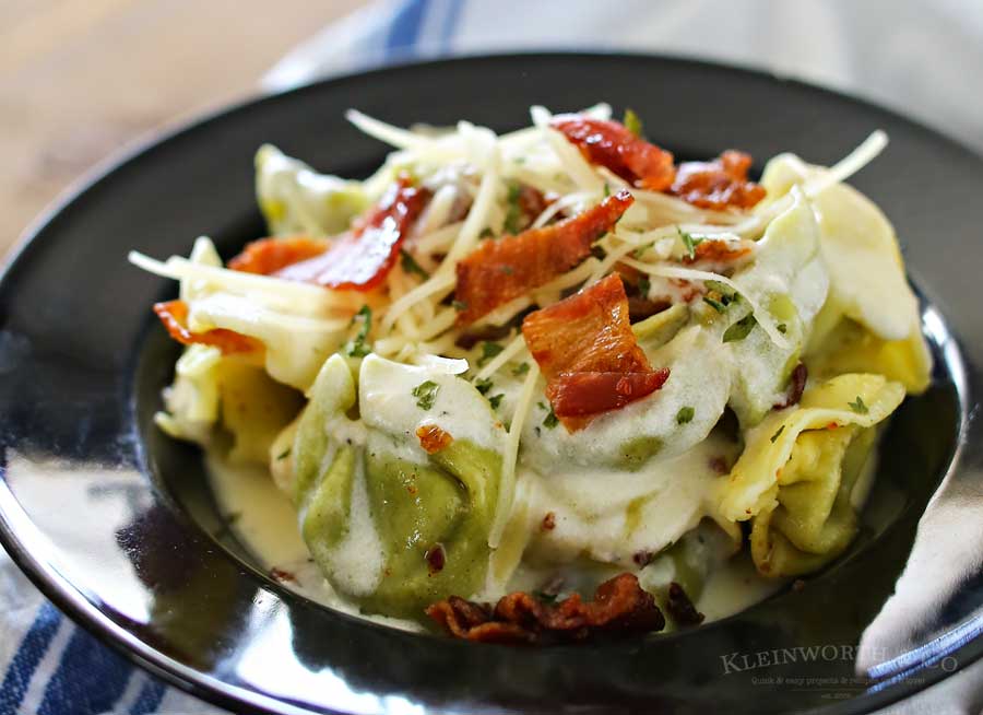 Bacon Alfredo Tortellini is an easy family dinner idea for bacon lovers everywhere. Homemade alfredo sauce, cheesy spinach tortellini & crispy bacon is good