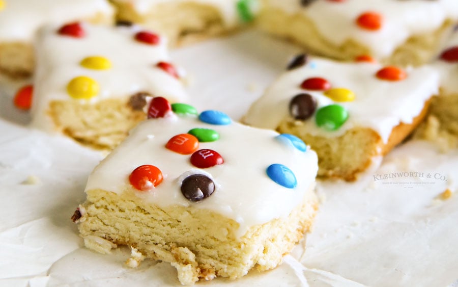 M&M Sugar Cookie Bars - deliciously frosted soft sugar cookie base, topped with mini m&m’s. You can’t go wrong with these.