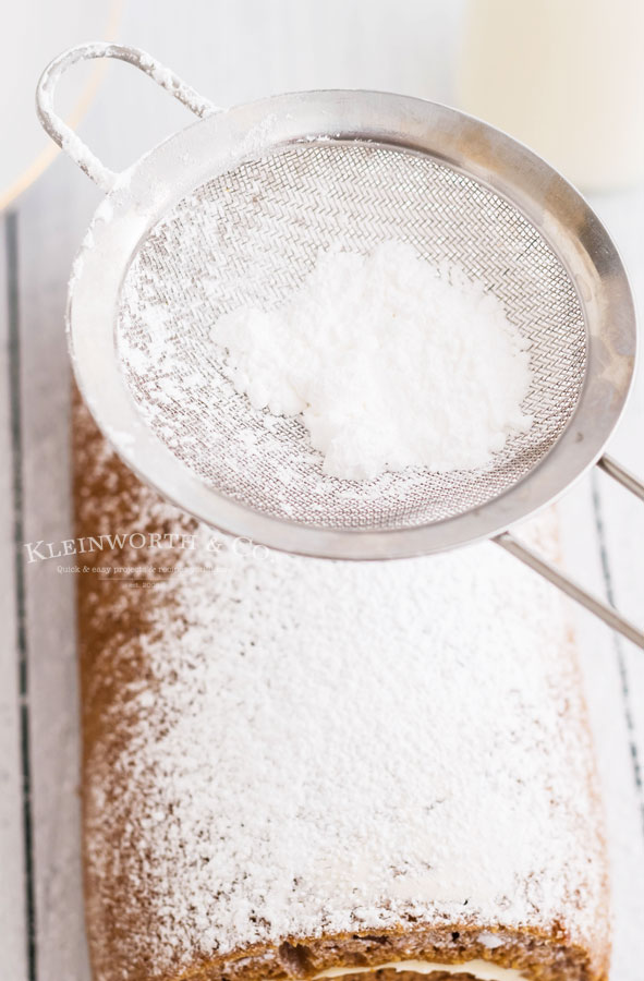 pumpkin roll cake with confectioner's sugar