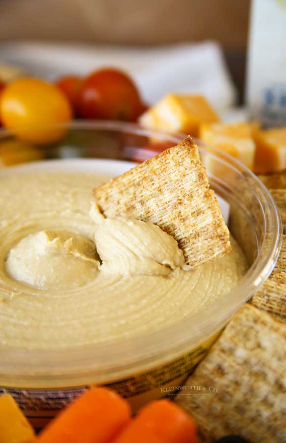 cracker in hummus dip