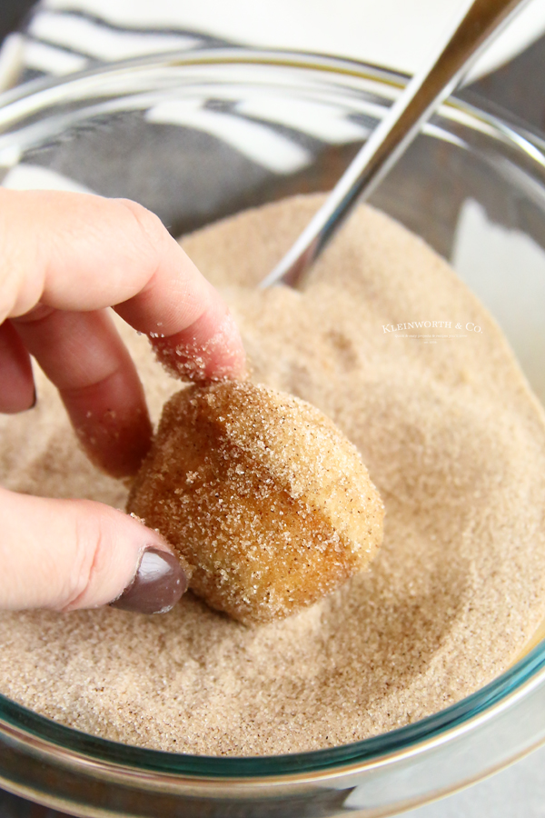adding the sugar coating to donuts