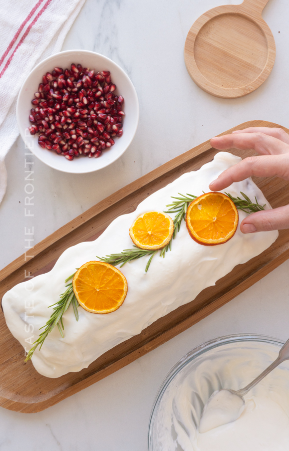 decorating cake with orange slices