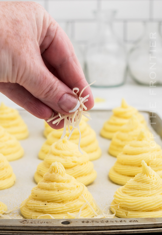 adding cheese to potatoes