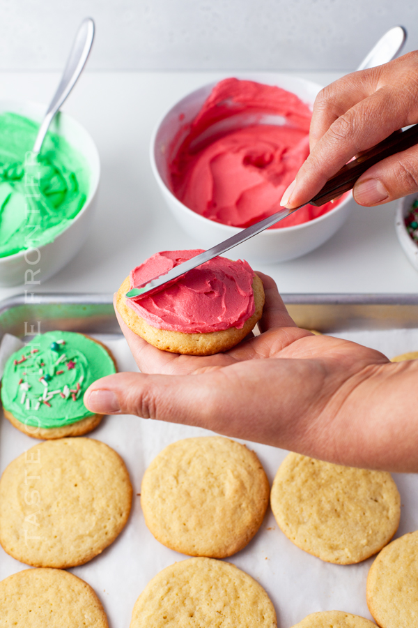 adding frosting to Christmas cookies