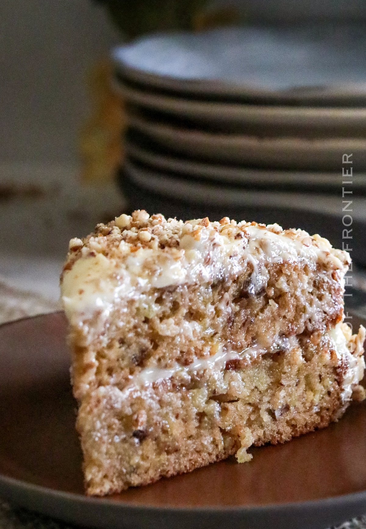 cake decorated with cream cheese frosting and pecans