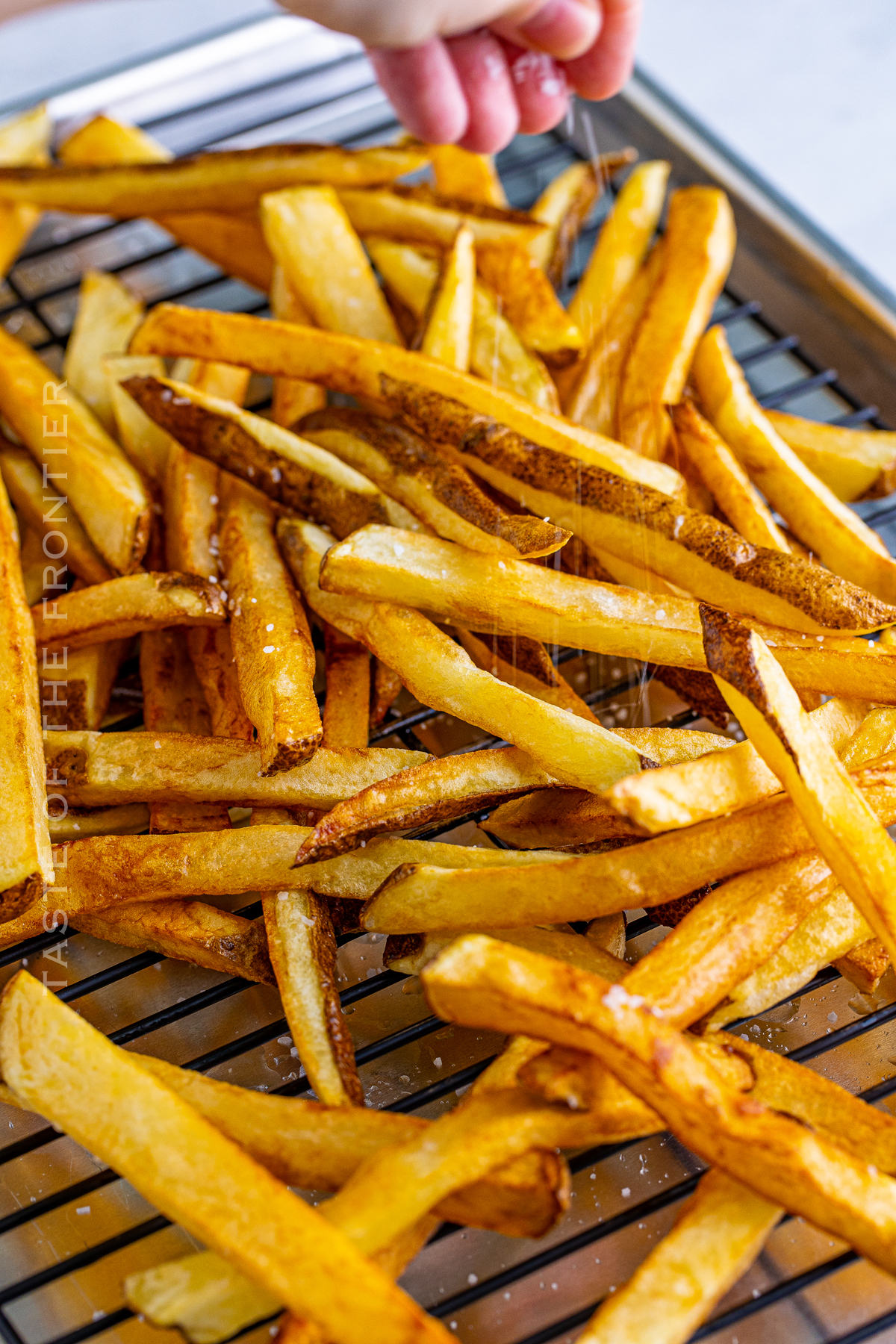 salting homemade french fries