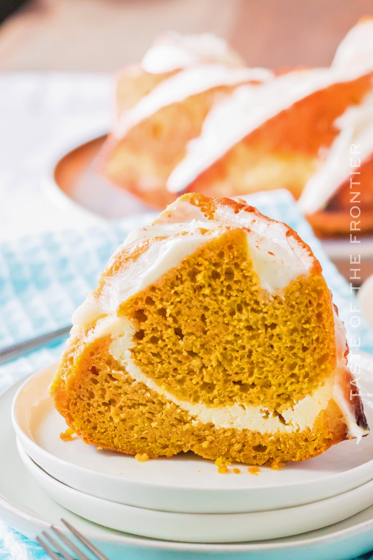 slice of pumpkin cake with cheesecake filling