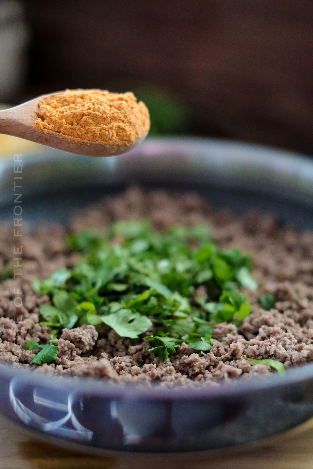 adding seasoning to the beef filling