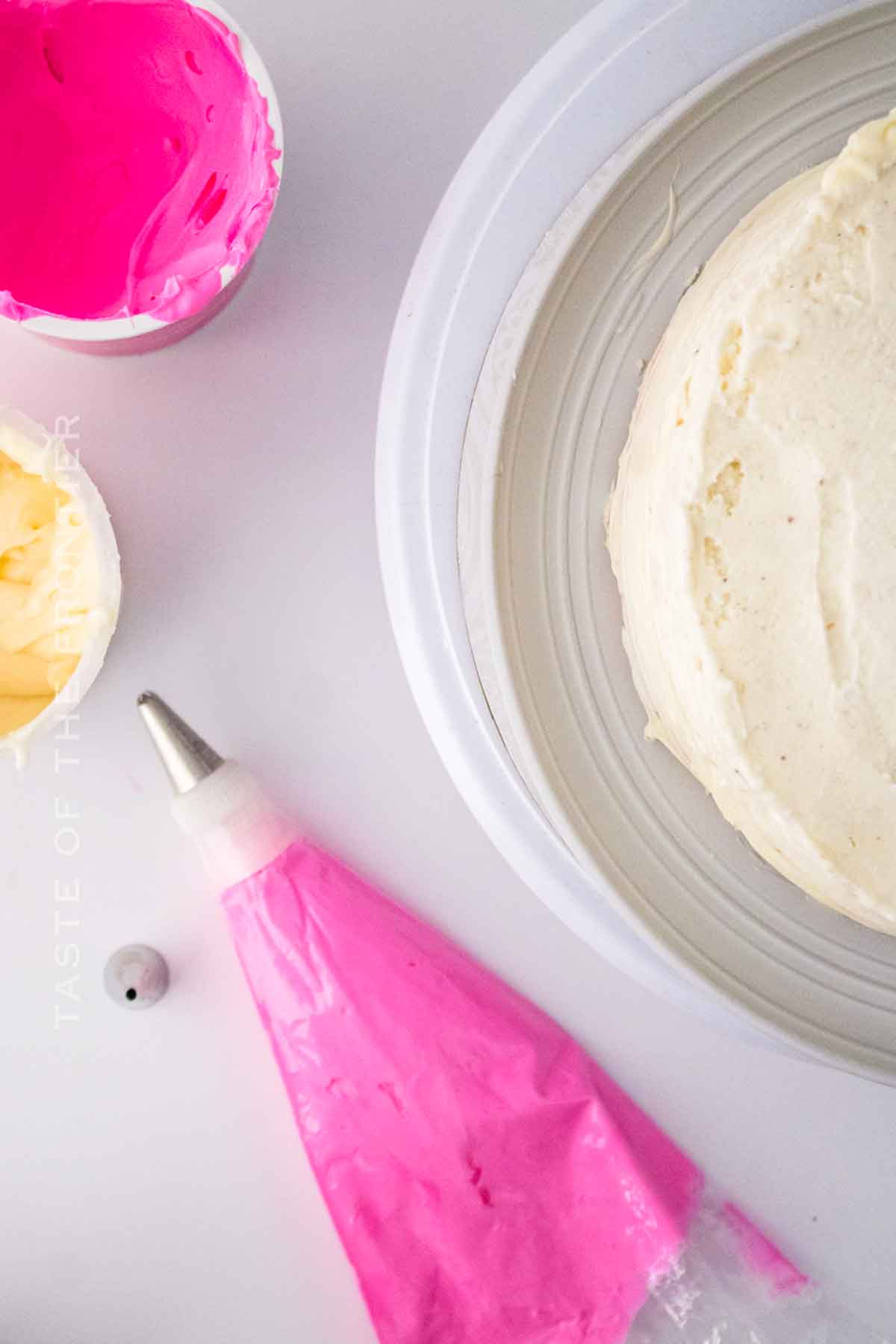 decorating the cake with pink frosting