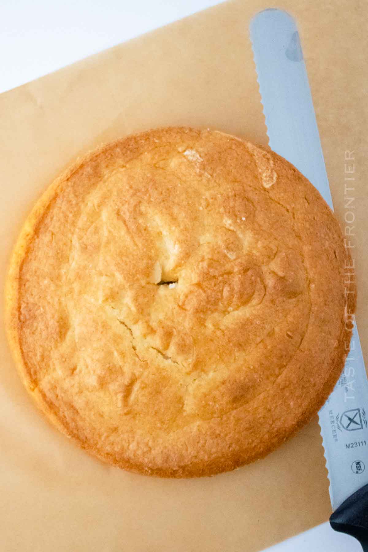 slicing the dome off of the baked cake