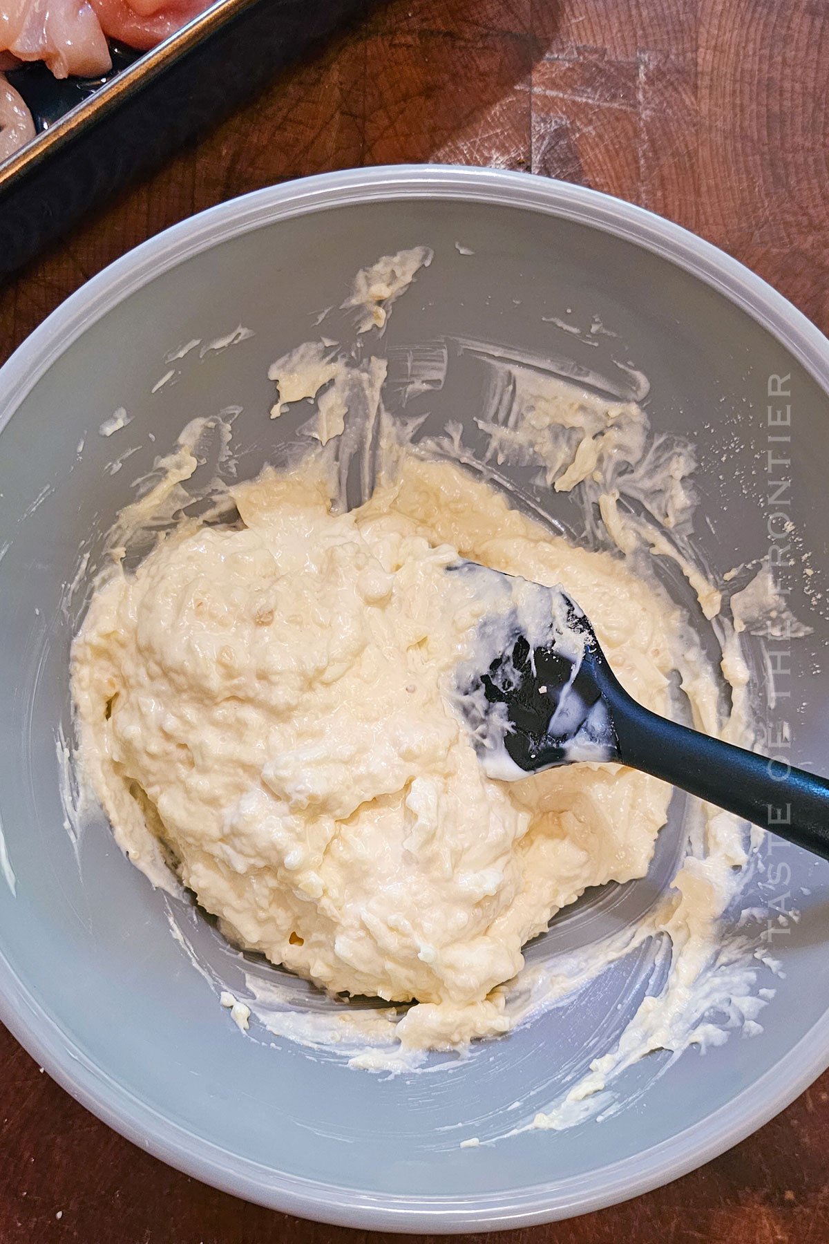 mixing the cheesy garlic topping