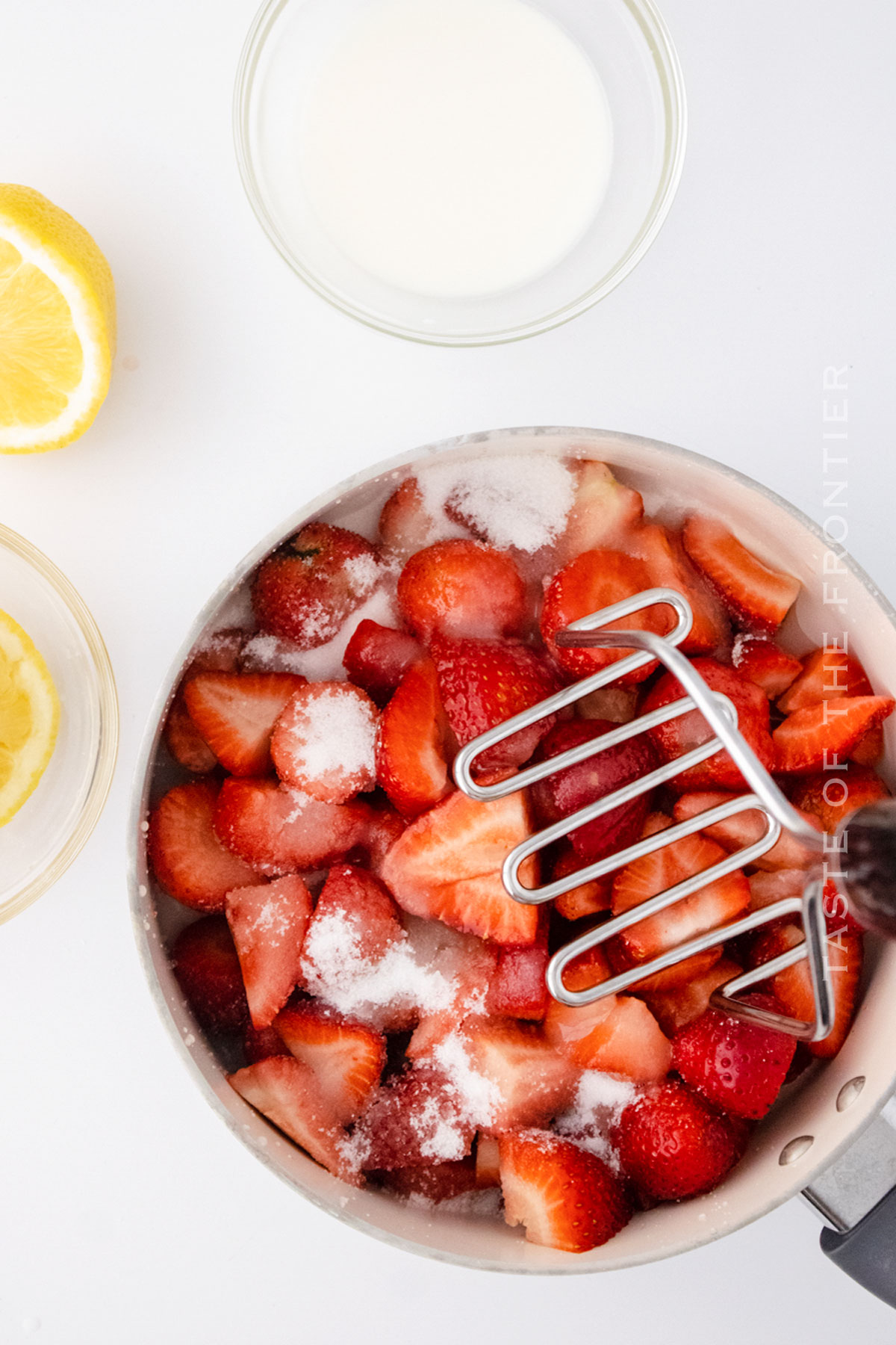 mashing strawberries