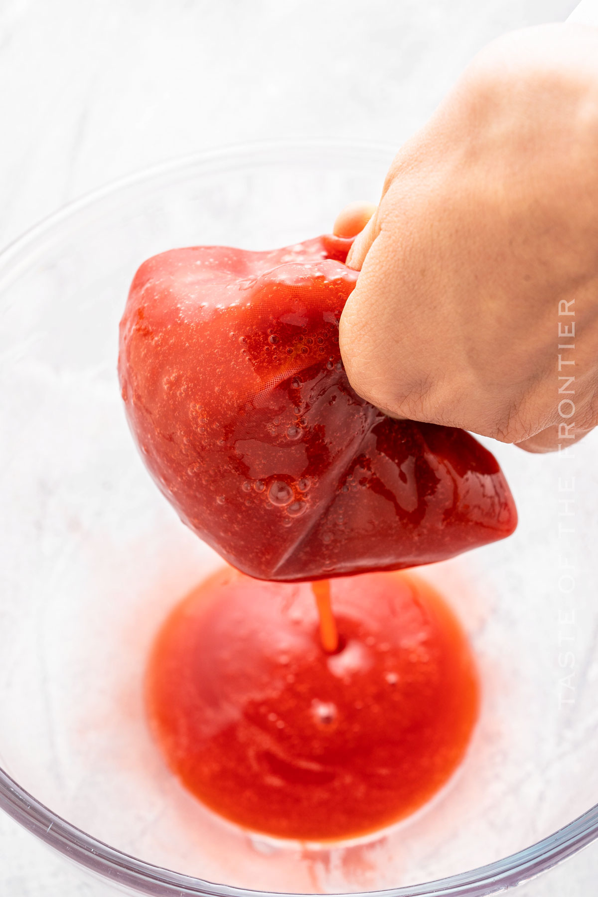 straining the strawberry mixture