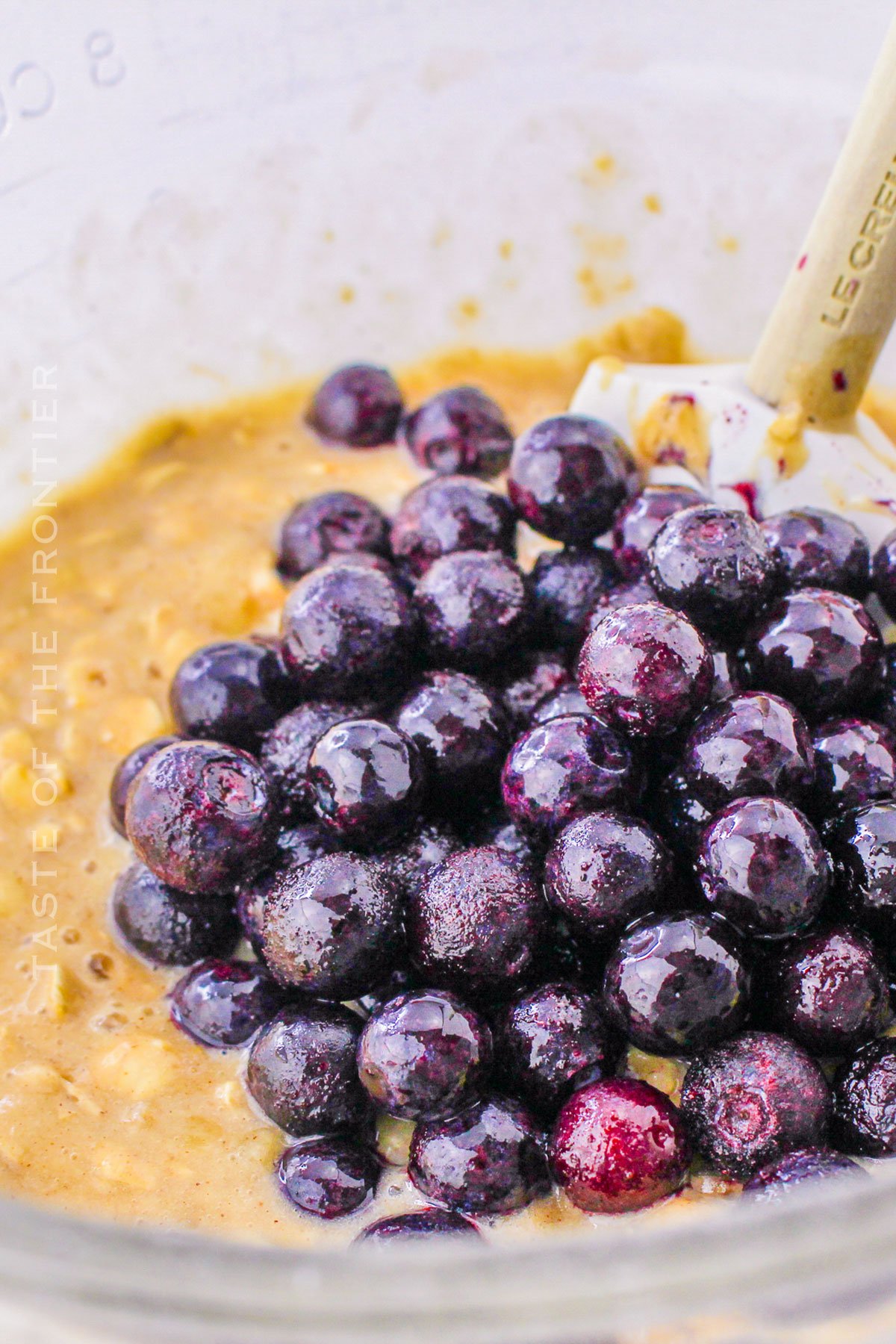 adding berries to the batter