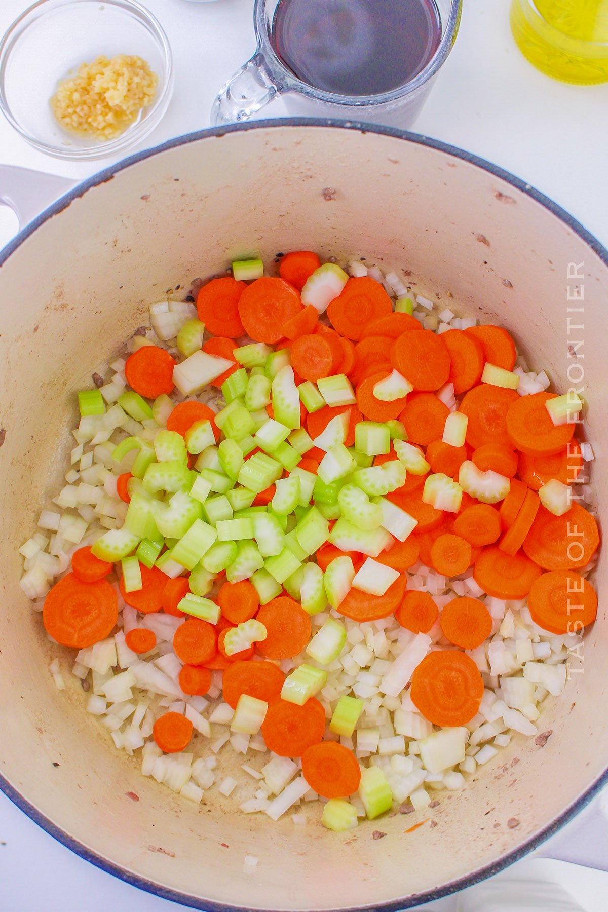 adding the veggies to the pot