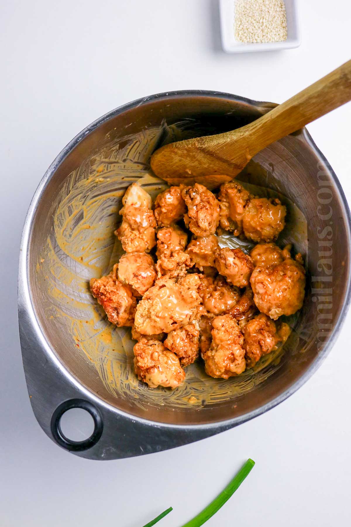 tossing to coat in sauce